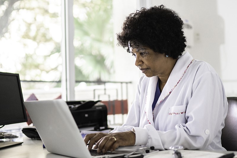 physician at laptop