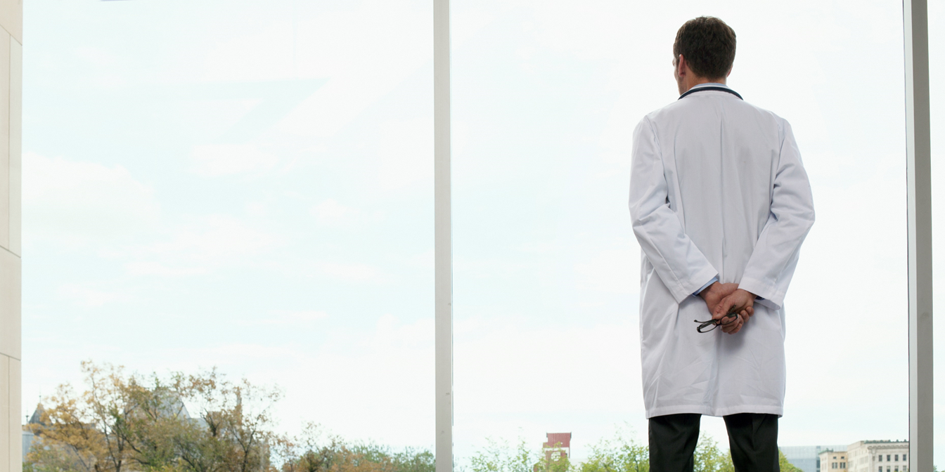 physician looking out a window