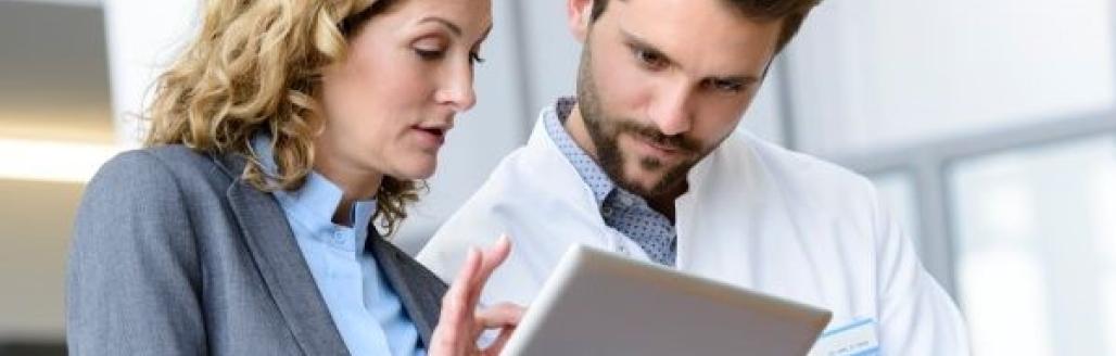 man and woman looking at tablet